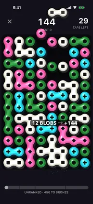 A twelve-blob group popping for 144 points while new blobs drop in from the top